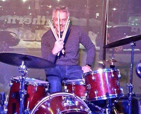 Arthur playing the drums.